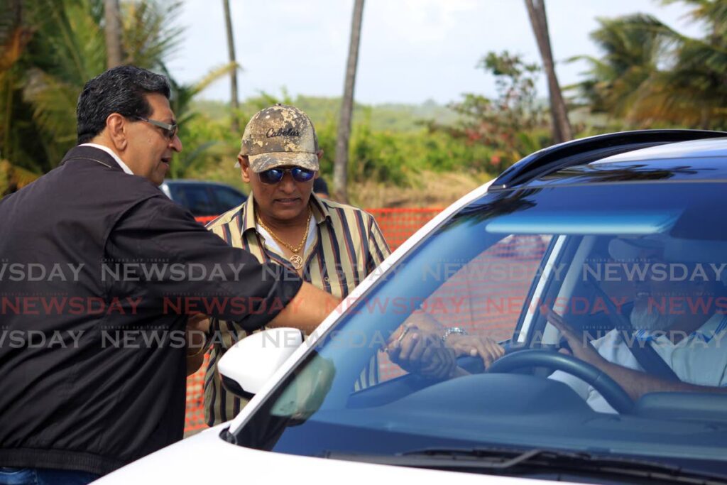 GREETINGS: Mayaro MP Rushton Paray greets driver Abdul Aziz while Works and Transport Minister Rohan Sinanan looks on during the opening of the temporary Mananilla/Mayaro Road on Monday. Photo Roger Jacob