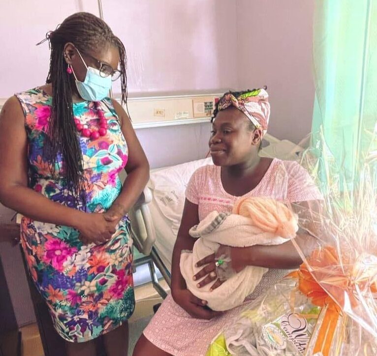 Secretary of Health Dr Faith BYisrael chats with Andrea Duncan-Bethel, mother of a newborn girl, on the maternity ward at the Scarborough General Hospital on Sunday.  Photo courtesy THA