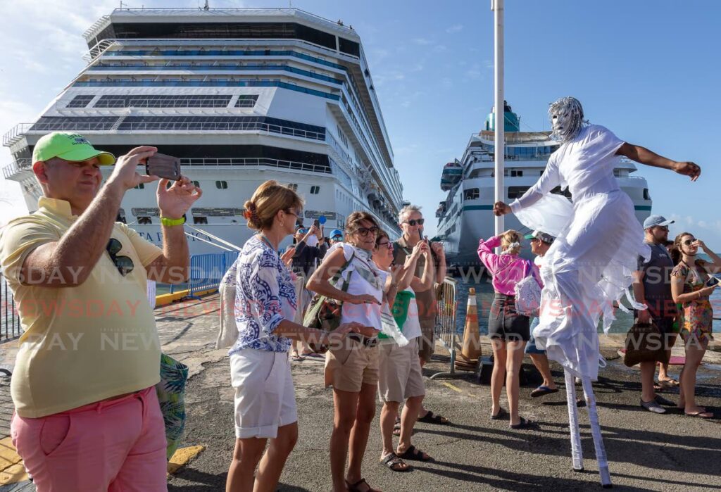 Moko jumbies entertain visitors who disembarked two cruise ships at the Port of Scarborough.  - David Reid