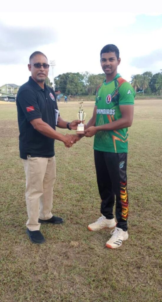 TTCB general secretary Altaf Baksh presents Hummingbirds player Justyn Gangoo with a Namalco U23 Cup man of the match award at Inshan Ali Ground, Preysal, last week.  - 