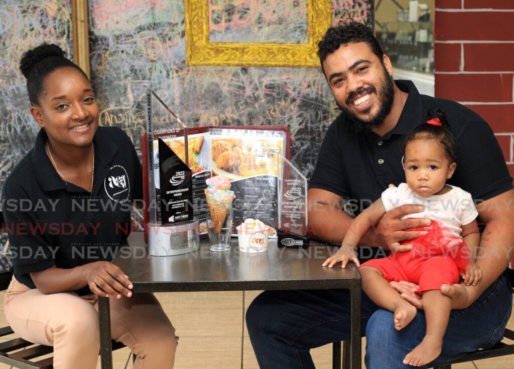 Owners of A & J Premium Ice Cream, June-Ann and Anthony Henry with their one-year-old Ava at their ice cream store in Charlieville. - ROGER JACOB