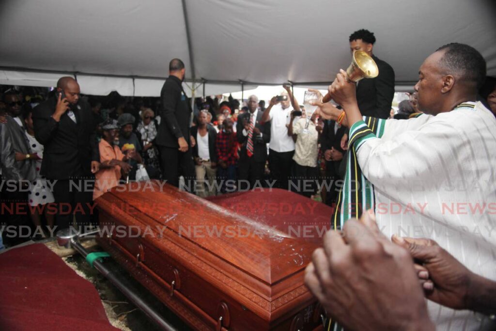 The coffin bearing the remains of Leroy "Black Stalin" Calliste is lowered into his final earthly resting place on Thursday afternoon at the Paradise cemetery in San Fernando. 