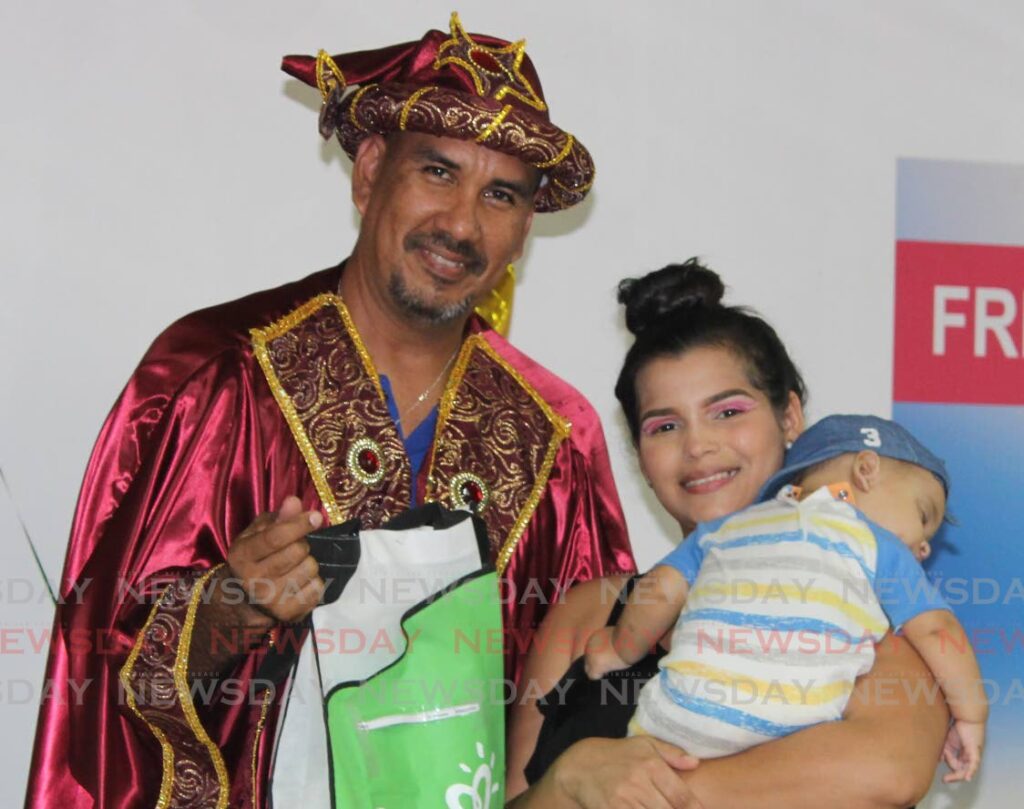 Baby Kheiler Sequea received his gifts from the Three Kings at La Casita of Arima on Friday. Photo by Grevic Alvarado