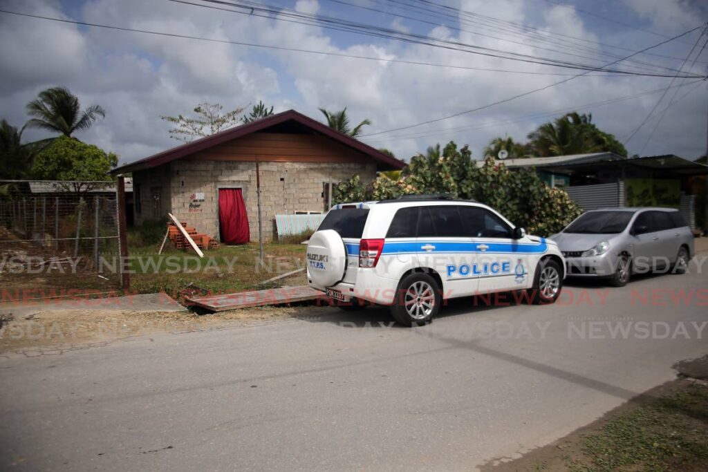 A police vehicle outside the house in Sangre Grande where six-year-old Kylie Maloney was gunned down on Sunday morning.