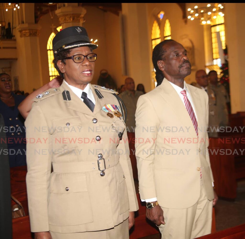Acting Commissioner of Police Erla Christopher and National Security Minister Fitzgerald Hinds stand during the inter-faith service.  