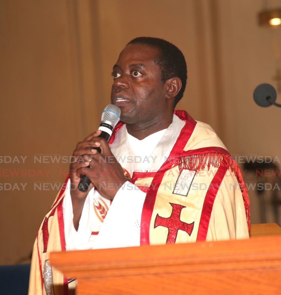 STAND UP: Fr Peter Aduaka speaks at the TTPS inter-faith service on Sunday at the Cathedral of the Immaculate Conception in Port of Spain. Photo by Sureash Cholai