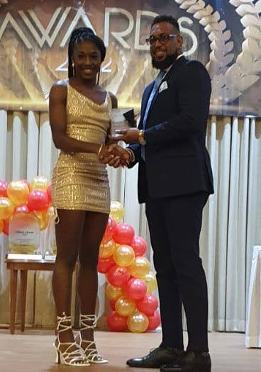 Shaniqua Bascombe, left, collects the junior sportswoman of the year award from National Gas Company chairman Dr Joseph Khan. Photo by Jelani Beckles