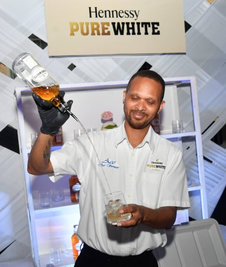 A bartender prepares a cocktail with Hennessy Pure White cognac at St Andrew’s Golf Club, Moka, Maraval, at the Never Stop. Never Settle party. Photo courtesy Overtime Media