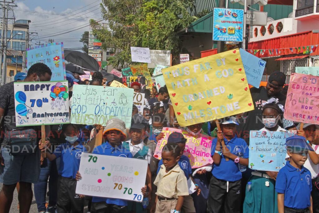 Students and parents of San Fernando Seventh-Day Adventist Primary School march with placards on Sutton Street, San Fernando on Monday, to celebrated the school's 70th anniversary. Photo by Marvin Hamilton