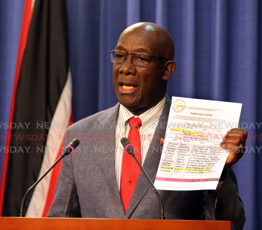 Prime Minister Dr Keith Rowley shows the nomination papers that then government member Kamla Persad-Bissessar signed in agreement for ANR Robinson to be TT president. Photo by Angelo Marcelle
