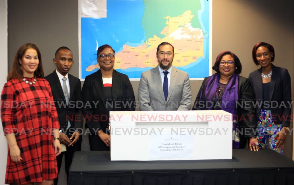 Energy Minister Stuart Young, centre, and from left, state counsel Louise Poy, geologist Keon Dube, PS Penelope Bradshaw-Niles, acting PS Sandra Fraser, geologist Kimberlee London at the opening of onshore/neashore bids, Energy Ministry, Port of Spain on Monday. - ROGER JACOB