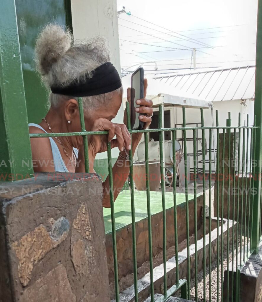 Maria Kowlessar, grandmother of murdered businessman Drew Kowlessar, mourns his death at their Sherwood Park residence, Eastern Main road, Arima on Wednesday. Drew was killed on Queen Street, Arima on Tuesday night.  Photo by Angelo Marcelle