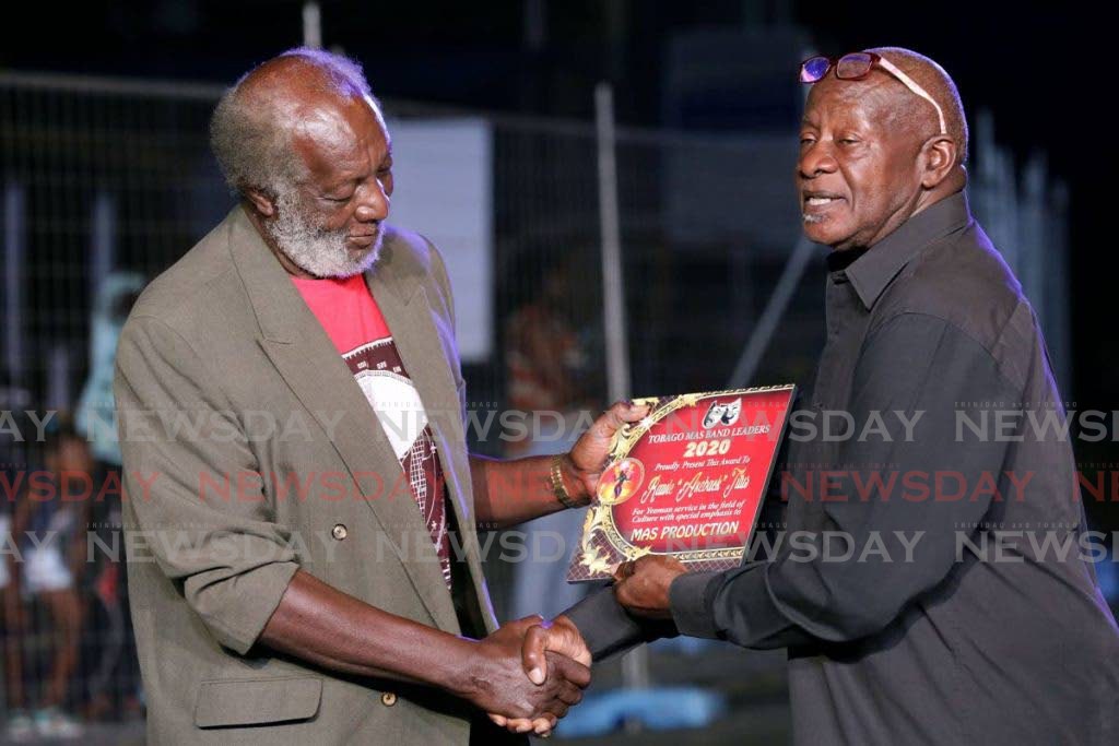 Rawle “Axeback” Titus, left, is presented with an award. - 