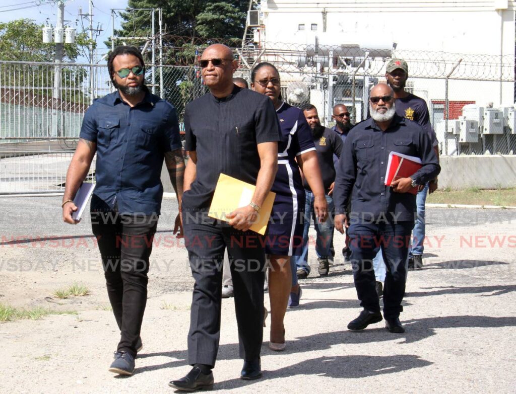 President general Ancel Roget, centre, and members of the OWTU make their way to deliver a letter to TTEC chairman Romney Thomas at the company's office at Mt Hope, on Friday. - ROGER JACOB