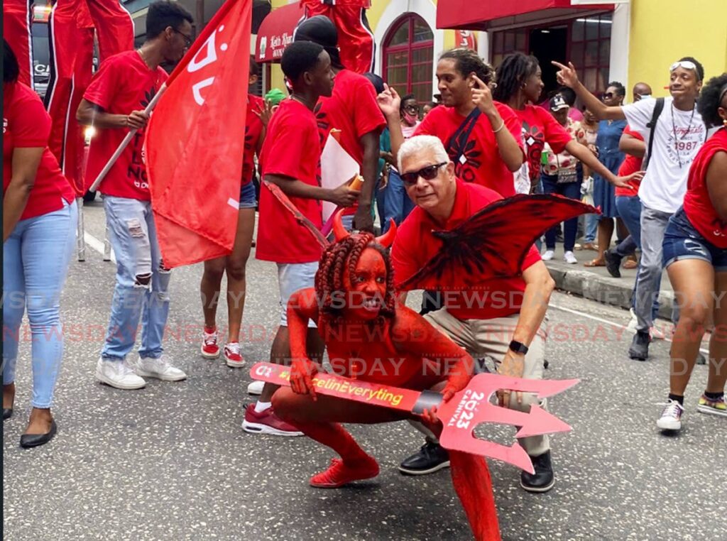 Port of Spain mayor Joel Martinez gets up close with a devil during the launch of downtown Carnival on Friday.  Photo by Narissa Fraser
