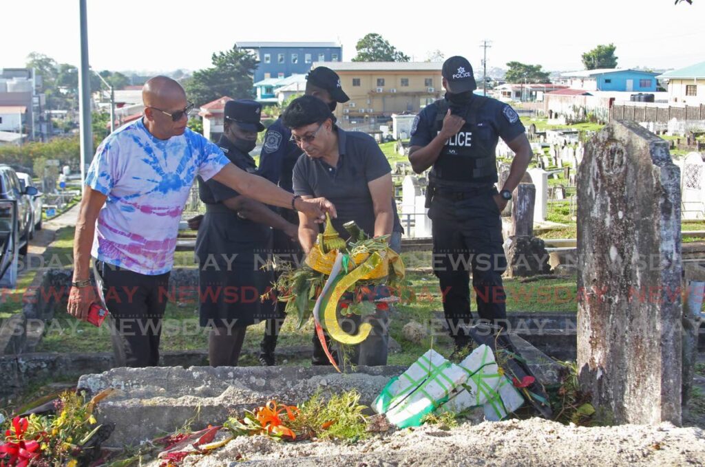San Fernando Mayor Junia Regrello and Councillor Ryaad Hosein inspect the vandalised tombstone on Saturday morning where the late Leroy 