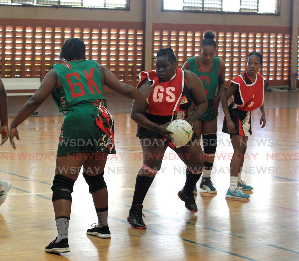 Goal shoot Dionne James of Fire Youth on the ball against Jabloteh in the Courts All Sectors Netball championship division on Saturday. - ROGER JACOB