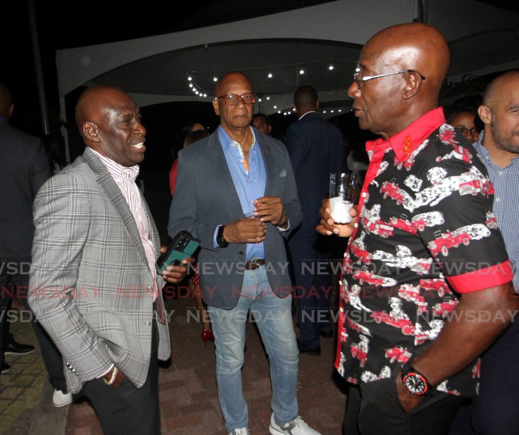 Prime Minister Dr Keith Rowley speaks with NLCB chairman Eustace Nancis while San Fernando Mayor Junia Regrello looks on at the PNM's media-appreciation event at the Hyatt Regency on Monday. Photo by Angelo Marcelle