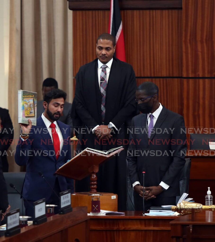 NEW ROLES: New government senator Richie Sookhai is sworn in by new Senate President Nigel De Freitas at the Red House on Wednesday. - Photo by Sureash Cholai