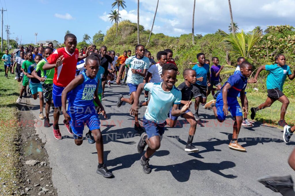 Primary school athletes take part in the THA’s Sport in Education Unit’s primary schools 3k road race, on Wednesday. The race started in Petit Trou  Beach, Lambeau and ended at the Shaw Park Hard Courts. - David Reid