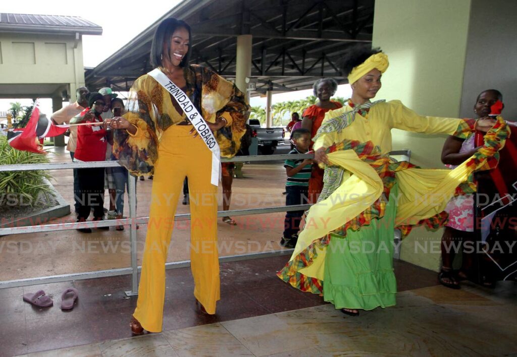 Miss Universe TT Tya Jané Ramey celebrates her return by dancing with a bele dancer at the Piarco International Airport, after she returned from the USA. - Photo by Angelo Marcelle
