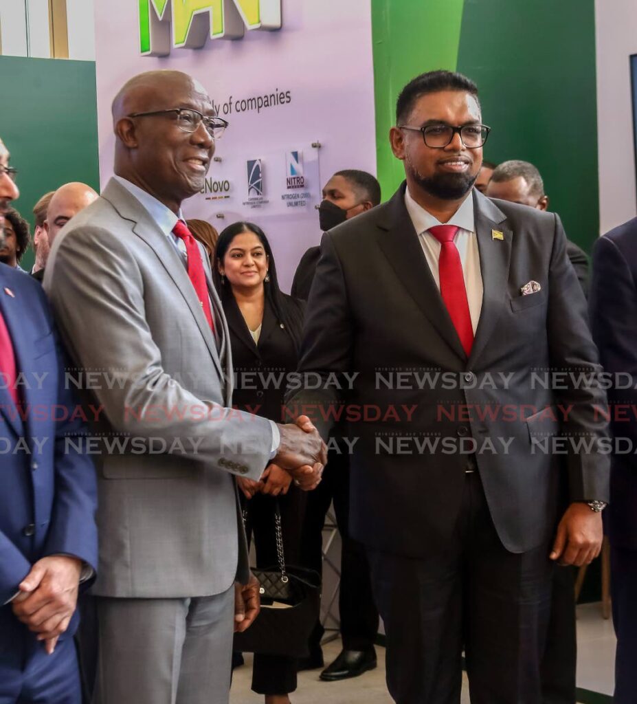 Prime Minister Dr Keith Rowley, left, greets Guyana's President Dr Irfaan Ali at the TT Energy Conference, Hyatt Regency, Port of Spain on Monday. - SUREASH CHOLAI