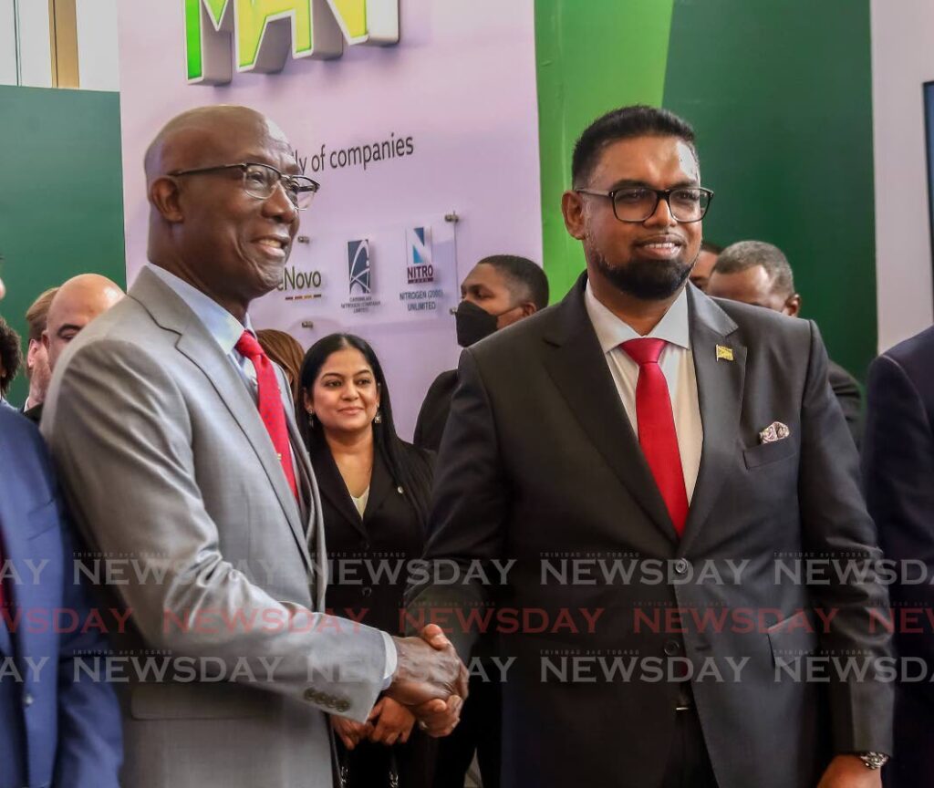CORDIAL: Prime Minister Dr Keith Rowley shakes hands with Guyana's President Dr Mohamed Irfaan Ali at the Energy Chamber's Energy Conference at the Hyatt Regency, Port of Spain on Monday. Photo by Sureash Cholai
