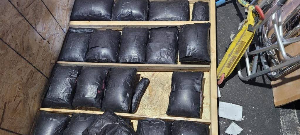 SEIZED: Black plastic packets containing compressed marijuana worth over $1million found hidden in a wooden crate at the Port in Port of Spain on Monday. Photo courtesy TTPS