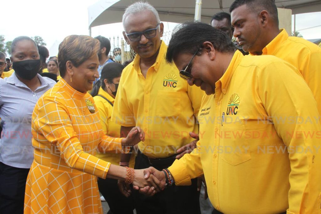 UNC political leader Kamla Persad-Bissessar is greeted by deputy political leader Dr Roodal Moonilal while Couva South MP Rudranath Indarsingh and other party supporters look on. - Marvin Hamilton