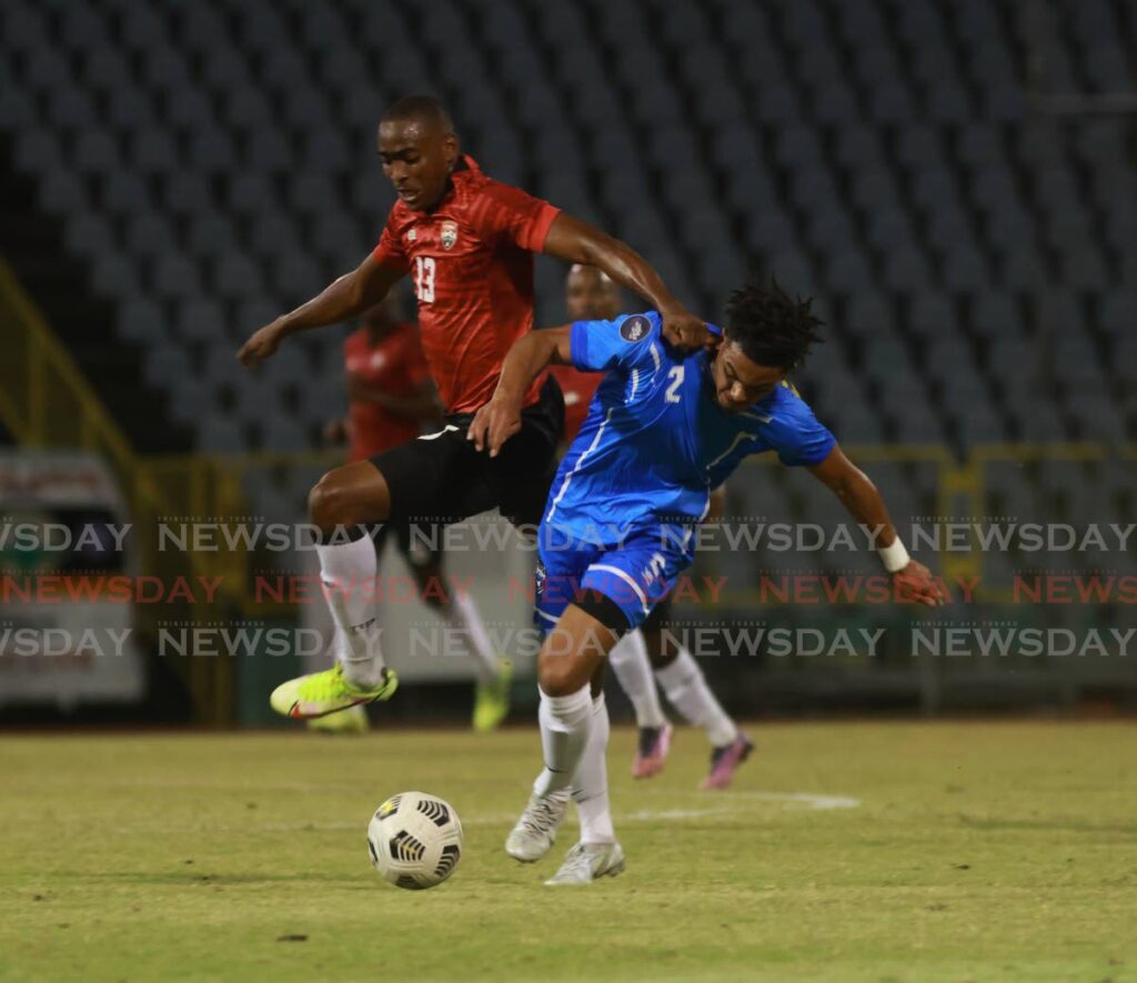 Trinidad and Tobago's Reon Moore, left, tussles  for the ball with St Martins Stephan Varsovie  during a friendly match at the Hasely Crawford Stadium, Mucurapo, Sunday. TT won 2-0. - Nicholas Bhajan