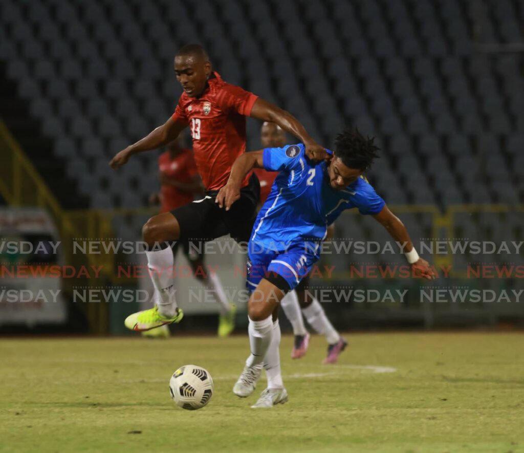 Trinidad and Tobago's Reon Moore, left, tussles for the ball with St Martins Stephan Varsovie during a friendly match at the Hasely Crawford Stadium, Mucurapo, Sunday. TT won 2-0. - Nicholas Bhajan