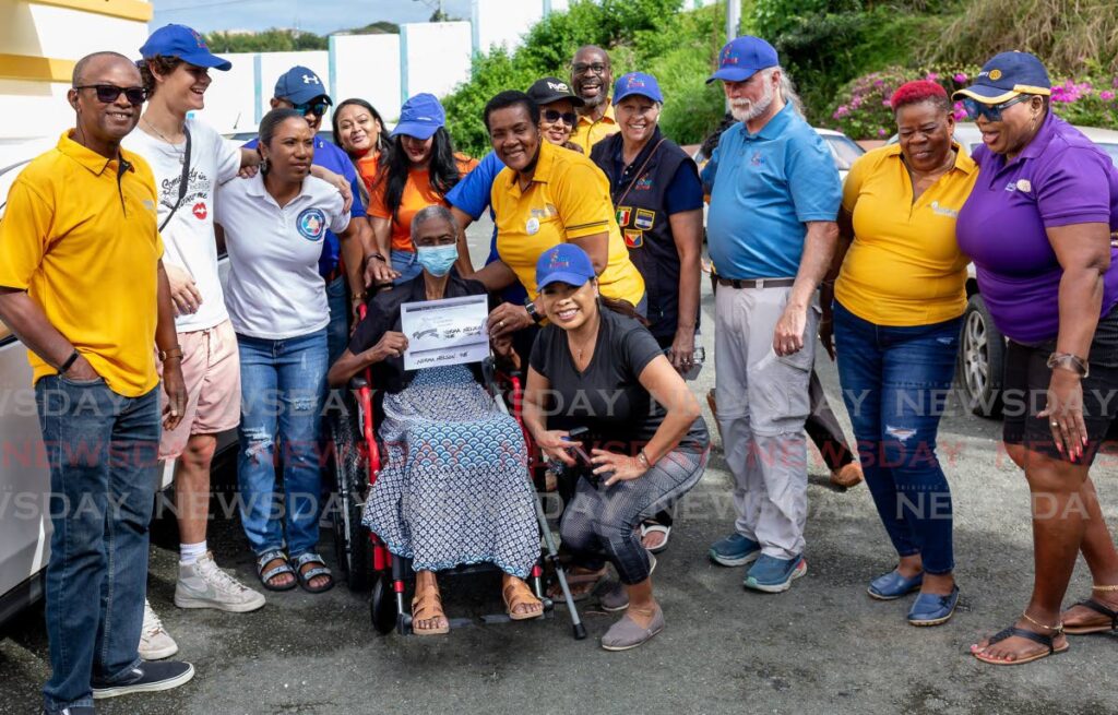 Norma Nelson, 76, with her new wheelchair from the Tobago Rotary Club and Chair the Love organisation, at a wheelchair distribution at Lambeau Multi-Purpose Facility, Tobago on Sunday.  - David Reid