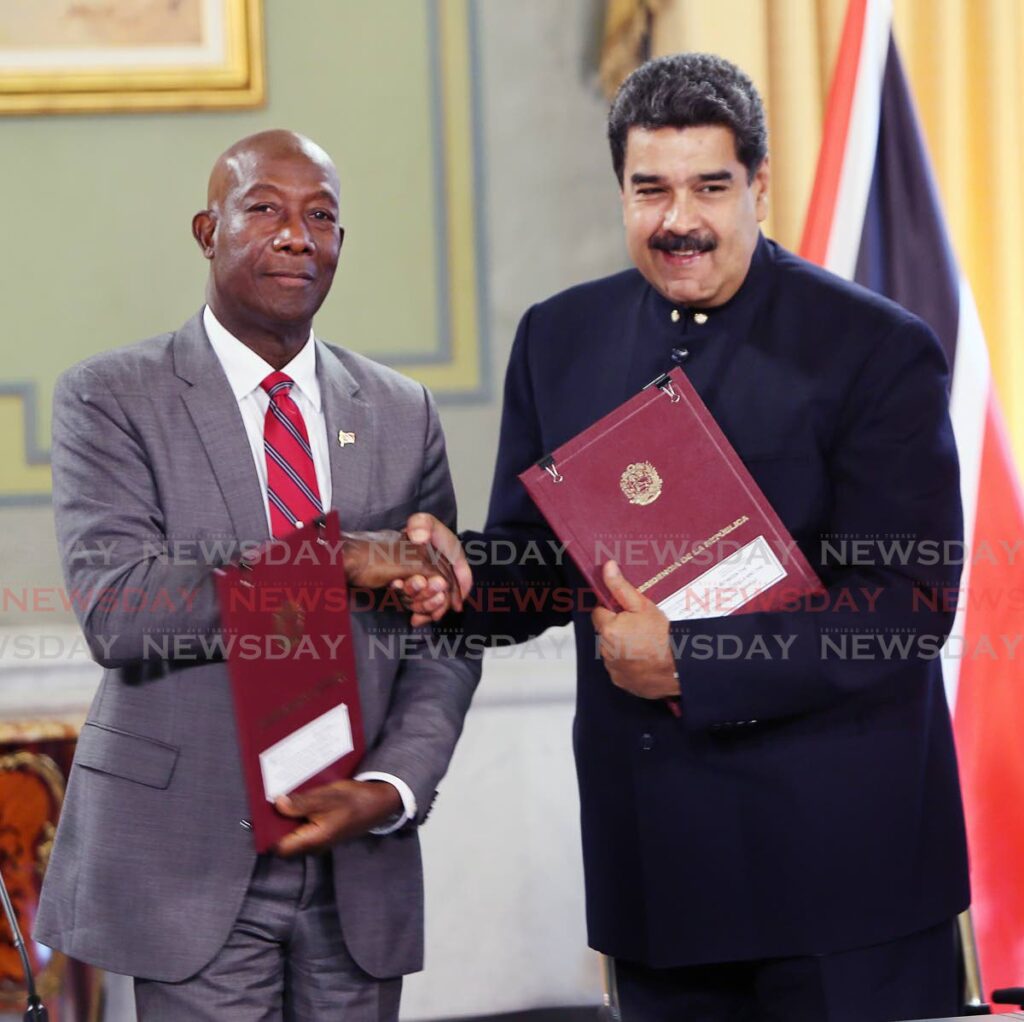 Prime Minister Dr Keith Rowley and Venezuelan President Nicolas Maduro after reaching an agreement for a natural gas exploration project in the Venezuelan-owned Dragon field in August 2018. - 