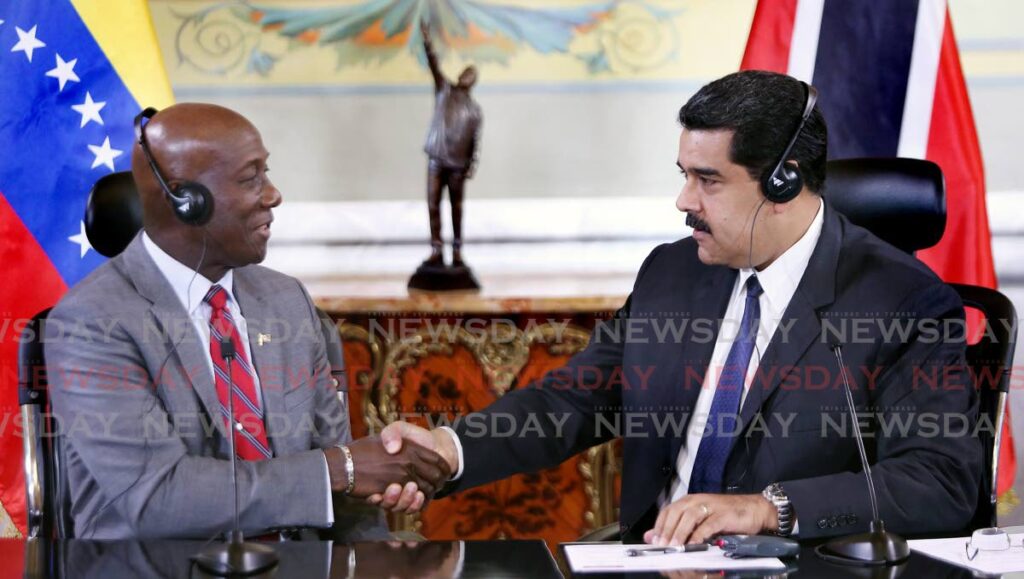 Prime Minister Dr Keith Rowley and Venezuelan President Nicolas Maduro shake hands after an agreement to negotiate a gas exploration agreement at Miraflores Palace, Caracase on December 5, 2016. The agreement for the Dragon gas deal was signed on August 25, 2018. - 