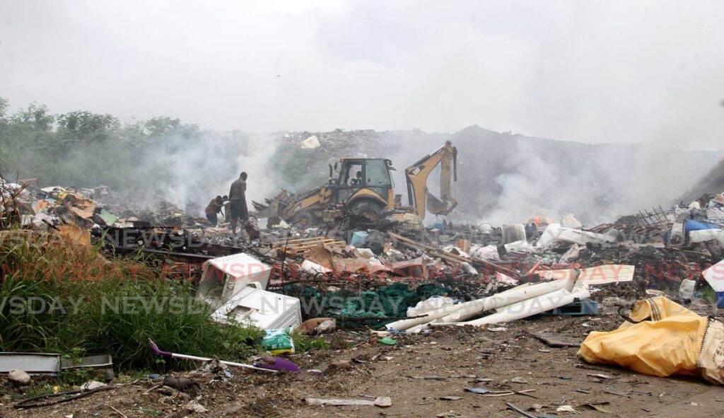 Men rummage through debris along Kangawood Road on the way to the Forres Park Landfill on June 30, 2021. - File photo/Angelo Marcelle