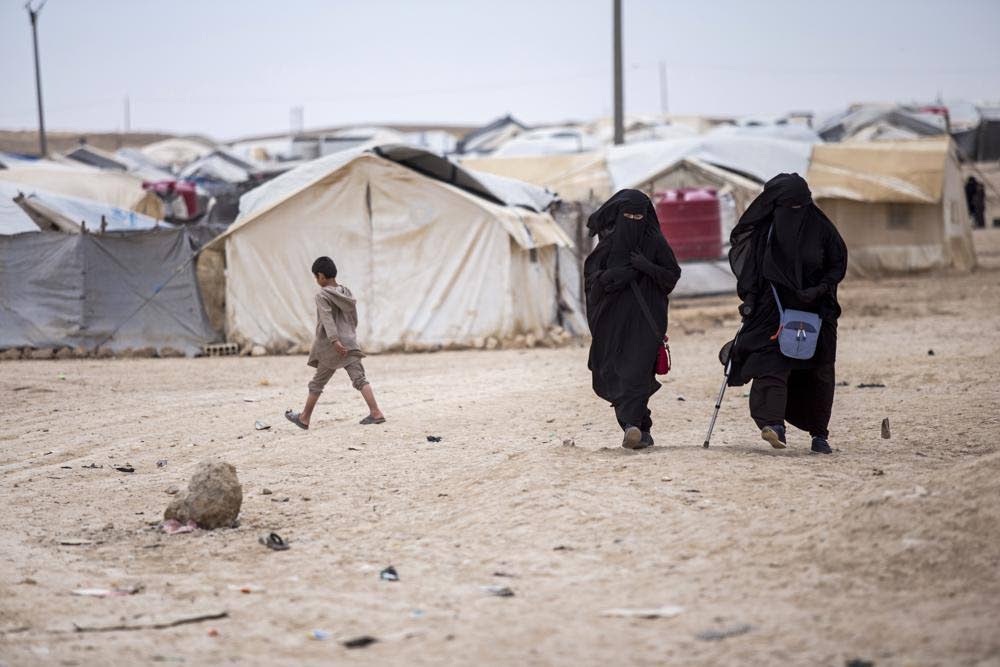 In this file May 2021 file photo, women walk in the al-Hol camp in Syria that houses some 60,000 refugees, including families and supporters of the Islamic State group, many of them foreign nationals. - AP PHOTO