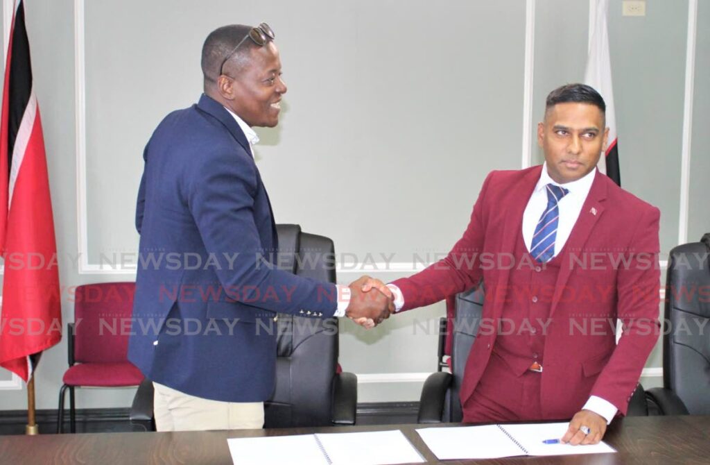 FILE PHOTO: CPO Dr Darryl Dindial, right, shakes hands with Gideon Dickson, head of the Police Social and Welfare Association after signing an MoA on a grievance process for police officers, last November. - 