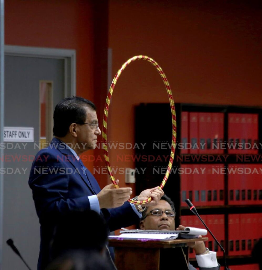 Ramesh Lawrence Maharaj, SC, lead counsel to the Paria Commission of enquiry, holds a ring similar in diameter to that of the 36-inch pipeline that five divers were working during a hearing on November 11, 2022. Four divers died on February 25, 2021. - 