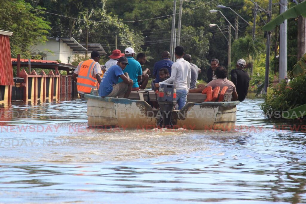 In this file photo, residents of the Bamboo #2 are evacauted from their homes during last November's devastating floods. - File photo/ROGER JACOB