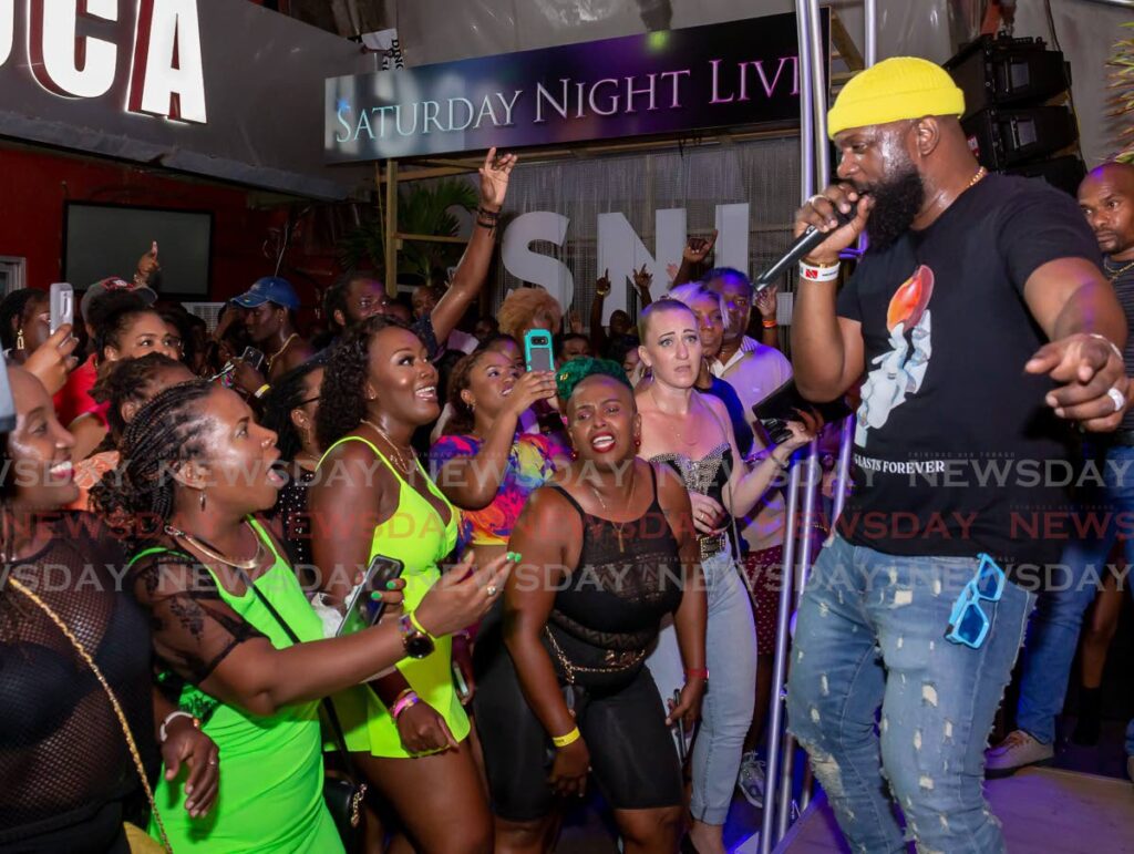 Bunji Garlin performs for fans during at I Love Soca launch at Bar Code, Scarborough, Tobago.  - Photo by David Reid