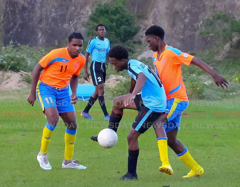 In this January 12 photo, Jaheim Roberts of Georgia FC, centre, controls the ball under pressure from two Roxborough Lakers players in the NLCL U-19 Community Cup match at Moriah Recreation Ground. - David Reid