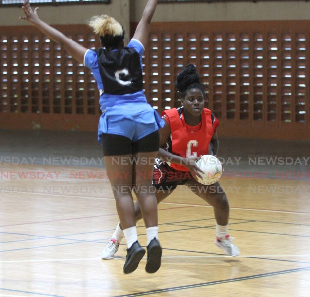 TTPost centre Shantelle Simeon avoids a challenge from a UWI player, during the Courts All Sector Netball League, at the Eastern Regional Indoor Arena, Tacarigua. FILE PHOTO - 