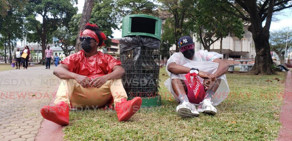 Singer and songwriter Raw Nitro and Yankey Boy pose in front of the fountain at Woodford Square to promote their  soca song Outside like Garbage. - Elexzine Bissoo