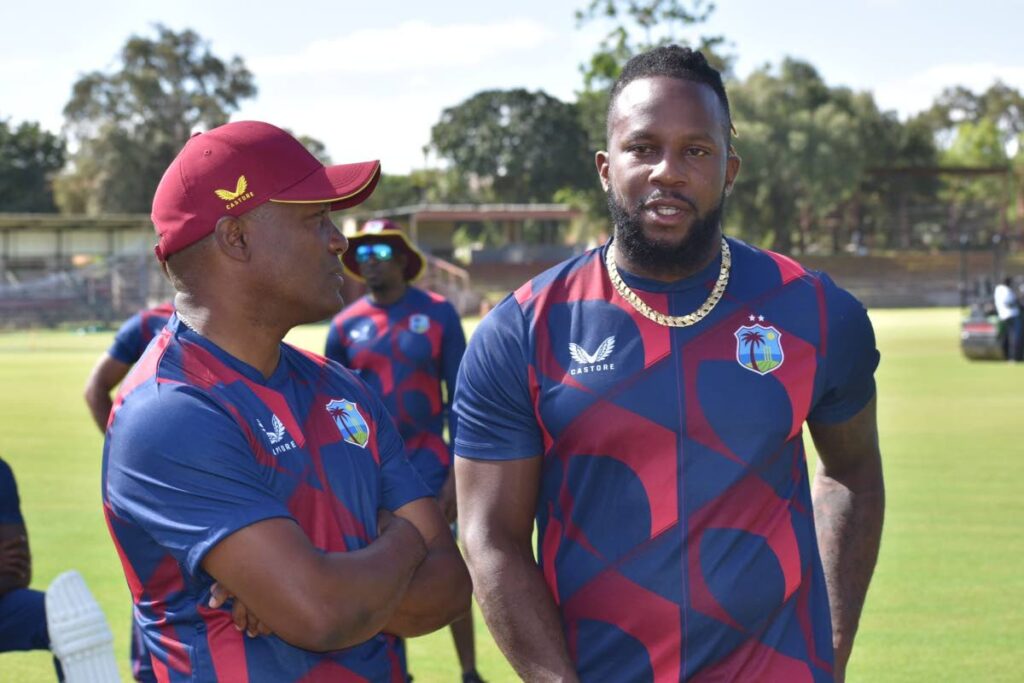 West Indies legend Brian Lara, left. speaks with batsman Kyle Mayers during a recent training session. - CWI Media