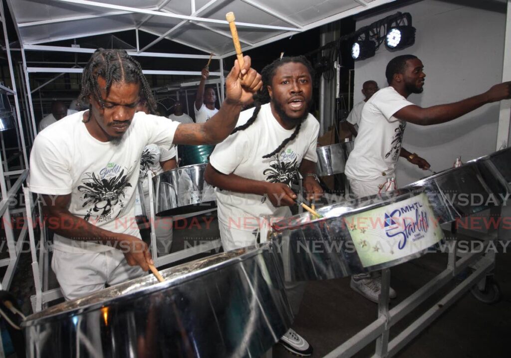 Proman Starlift players enjoy their performance during the large conventional bands panyard judging in Port of Spain on January 31. The band plays first at the Panorama finals on Saturday. - Angelo Marcelle