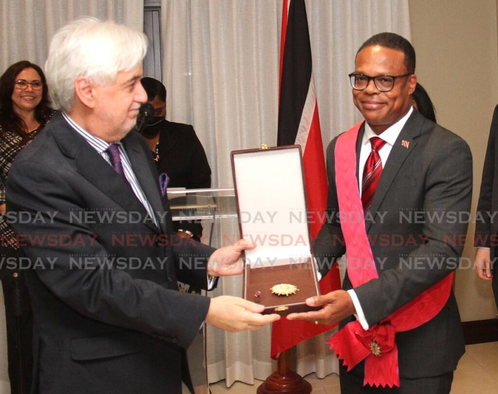 AWARD: Juan Aníbal Barría, left, outgoing ambassador of Chile presents Foreign and Caricom Affairs Minister Dr Amery Browne with the Grand Cross of the Order of Bernardo O'Higgins, Chile's highest honour for non-nationals, during a ceremony at the ambassador's official residence in St Clair on Thursday. PHOTO BY AYANNA KINSALE - 