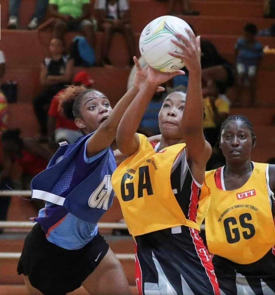 A UTT players collects a pass in the Courts All Sectors Netball League at the Eastern Regional Indoor Arena, Tacarigua. - Courts All Sectors Netball