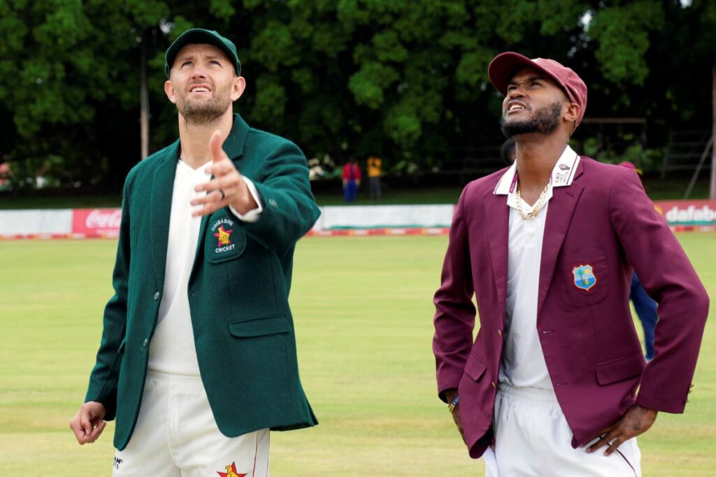 HEADS OR TAILS: Zimbabwe captain Craig Ervine (L) tosses the coin next to West Indies captain Kraigg Brathwaite on the first day of their Test match at Queens Sports Club in Bulawayo, Zimbabwe, on Saturday. (AP Photo) 