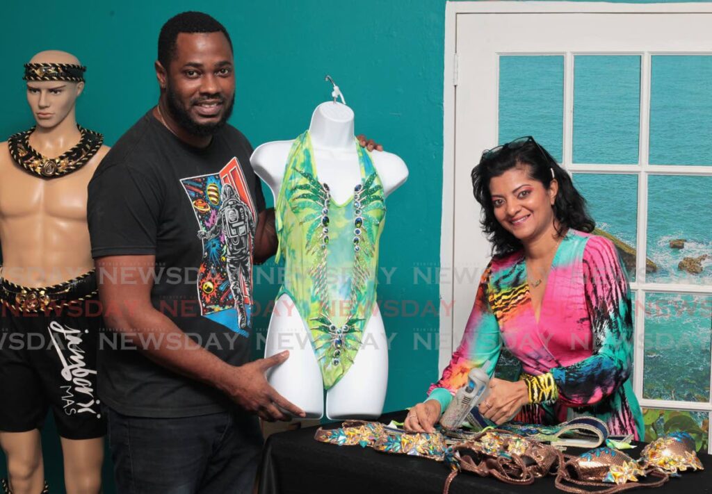 Jamborii bandleaders Devika Singh and Franklyn Mayers work on costumes for their band Nostalgia at the mas camp, Woodford Street, Port of Spain. Photo by Roger Jacob