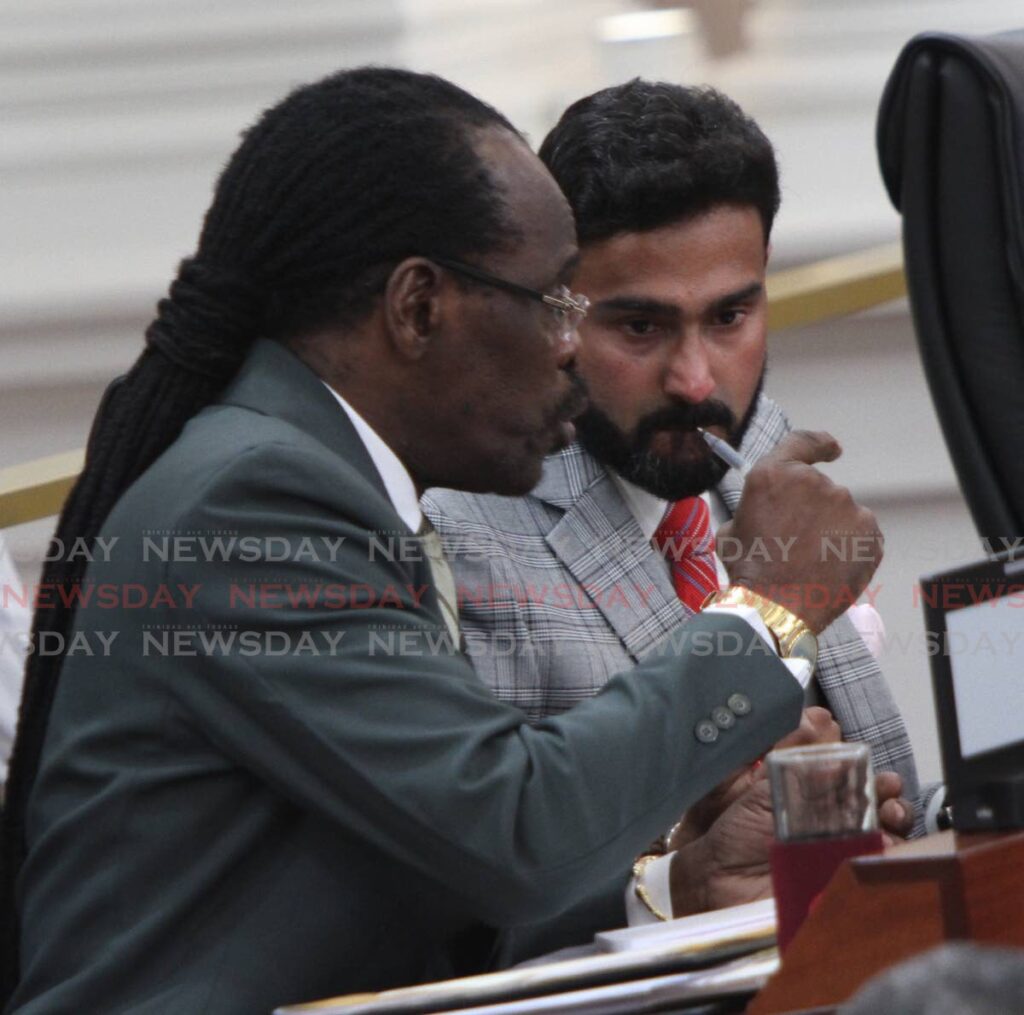 Minister of National Security Fitzgerald Hinds, left, makes a point to Senator Rishi Sookhai in the Senate during the debate on the Firearms (Amendment) Bill. - ANGELO MARCELLE
